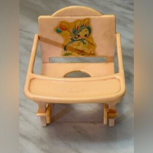 This is a vintage miniature plastic dollhouse high chair, 1940s-1960s.